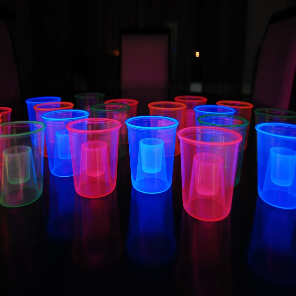 DIRECTGLOW LLC 4oz 20ct Assorted Blacklight Reactive Soft Plastic Bomber Shot Glasses