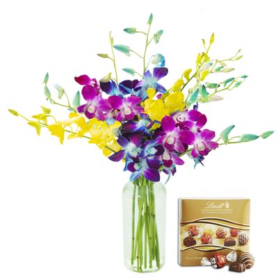 KaBloom Exotic Rainbow Orchid Bouquet of Blue, Purple and Yellow Orchids from Thailand with Vase and One Box of Lindt Chocolates