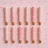 Gender Reveal Pink Chocolate Pretzel Rods with Pink Sprinkles and assorted toppings view 1