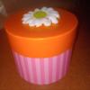 Expressions 3" H x 4.75" W x 3" D Round Gift Box with Pink Striped Sides & an Orange Lid Topped With a 3D White Flower With a Green Center view 1