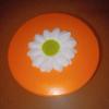 Expressions 3" H x 4.75" W x 3" D Round Gift Box with Pink Striped Sides & an Orange Lid Topped With a 3D White Flower With a Green Center view 3