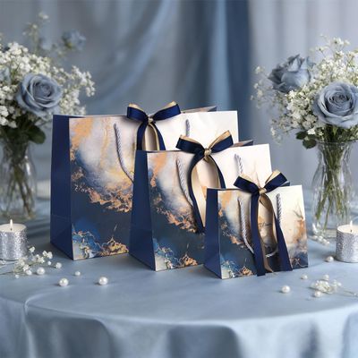 DONQE Paper Gift Bags with Handles and Bow Ribbon, S+M+L Goodie Bags Bulk, Reusable Party Favor Bags for Birthday Wedding Valentine's Day, Mother's Day Blue
