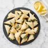 Spanakopita, a beloved Greek pastry that delights the senses with its layers of flaky phyllo dough and savory spinach filling. Crafted with care, each bite of this Spanakopita delivers a symphony of flavors and textures. The Spanakopita features a lu view 4